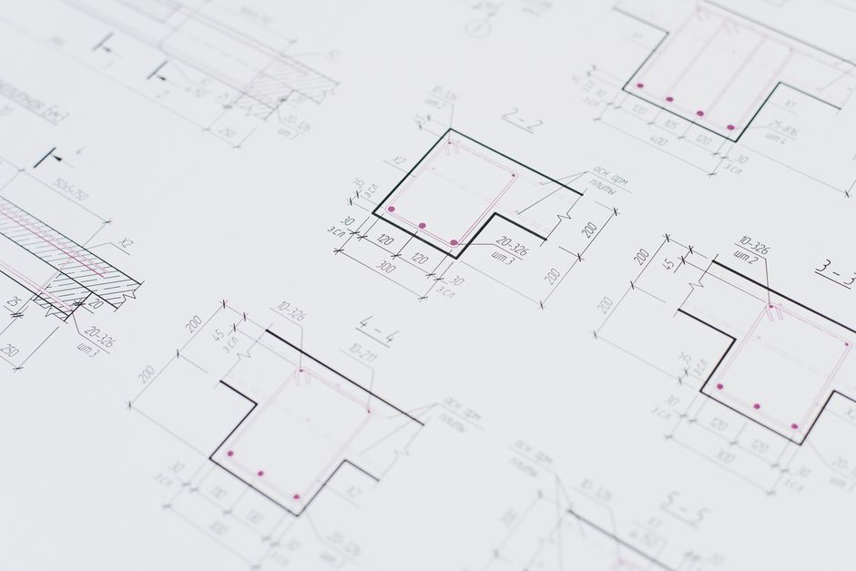 High-resolution close-up of detailed architectural blueprints showcasing precision design layouts.